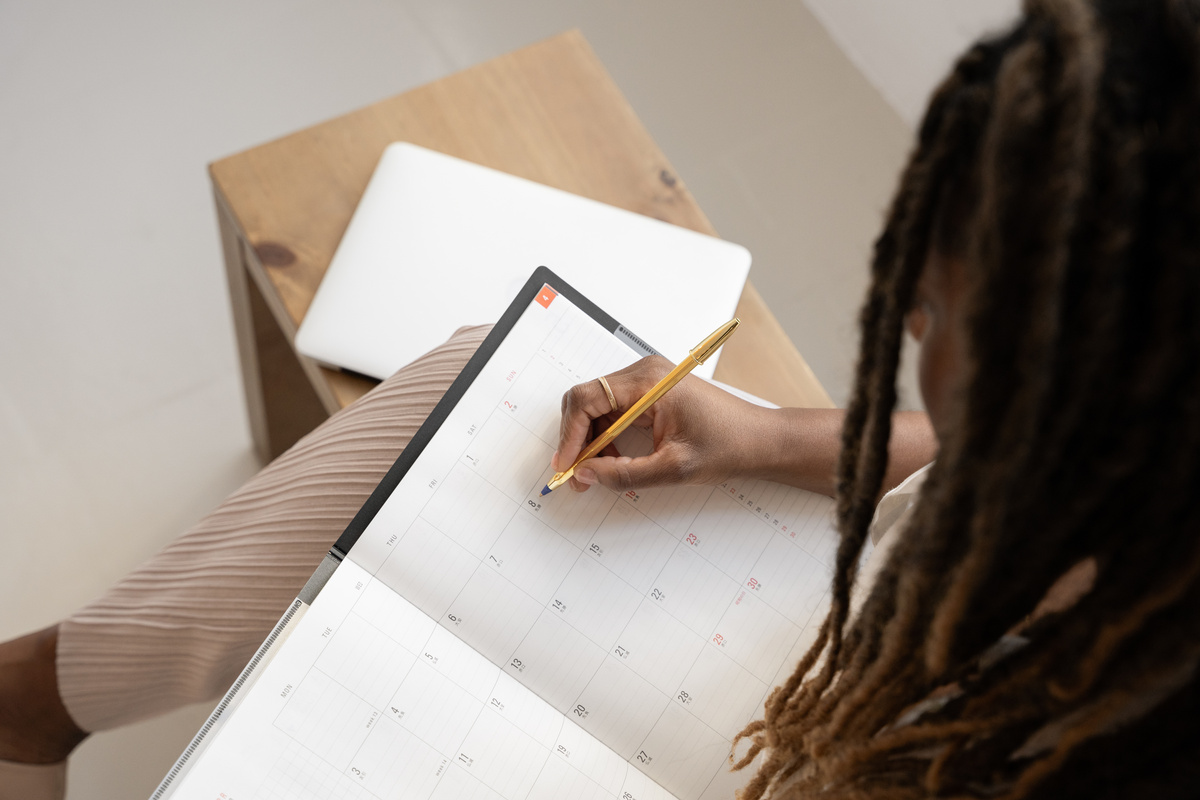 Elegant Office Business Woman Writing on a Planner